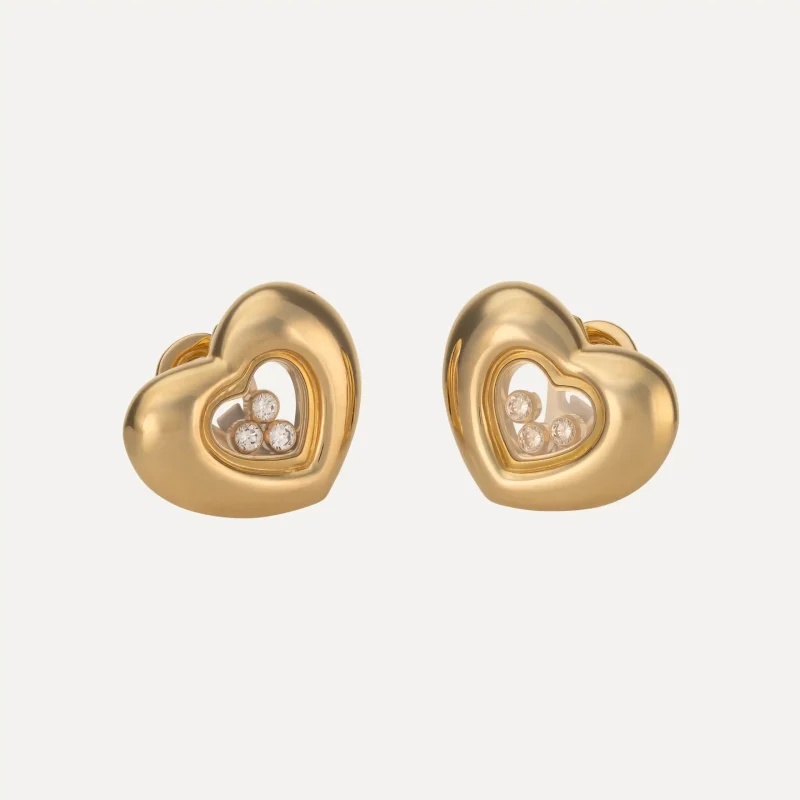 Chopard Happy Diamonds earrings in 18kt yellow gold with heart-shaped movable diamonds.